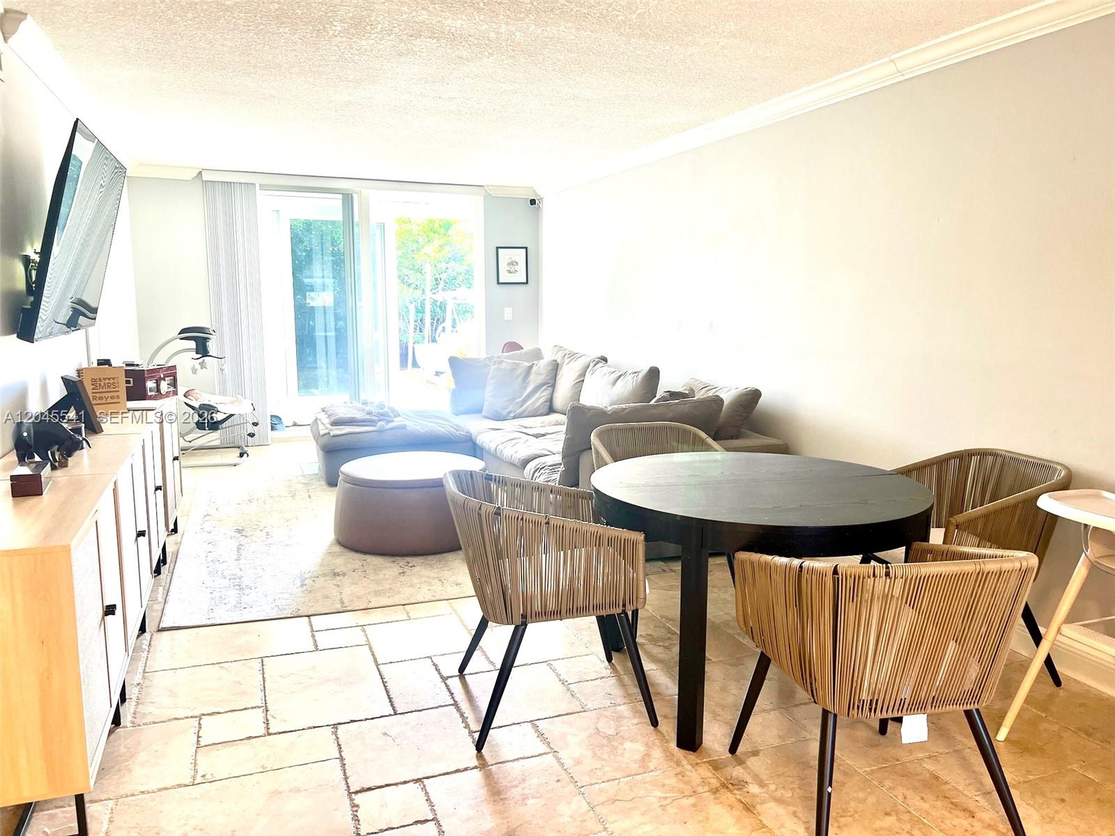 A living and dining area features tile flooring, a sectional sofa, and a round table — 689 NE 6th Ct # 1080, Boynton Beach FL 33435, BOYNTON BEACH, FL