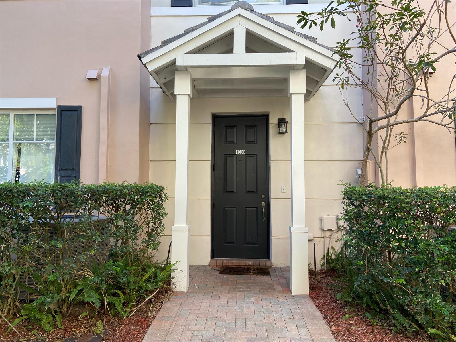 A black front door with a white portico stands at the entrance of a home — 3803 NW 5th Terrace, Boca Raton FL 33431, BOCA RATON, FL