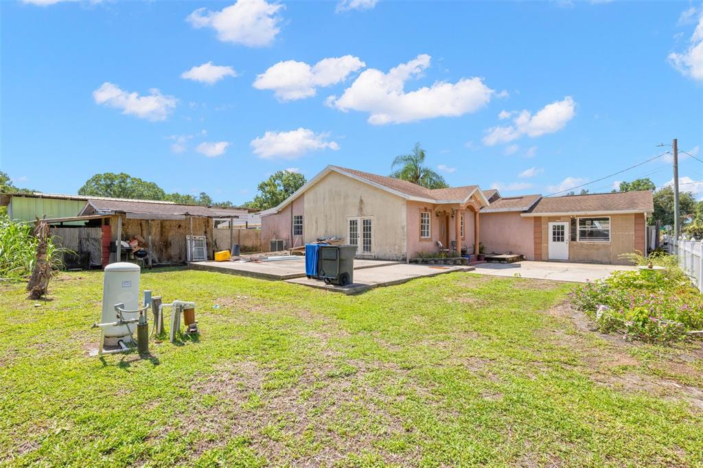 A pink house with a concrete patio and a detached shed in the backyard — 2442 SHIRAH ROAD, AUBURNDALE, FL