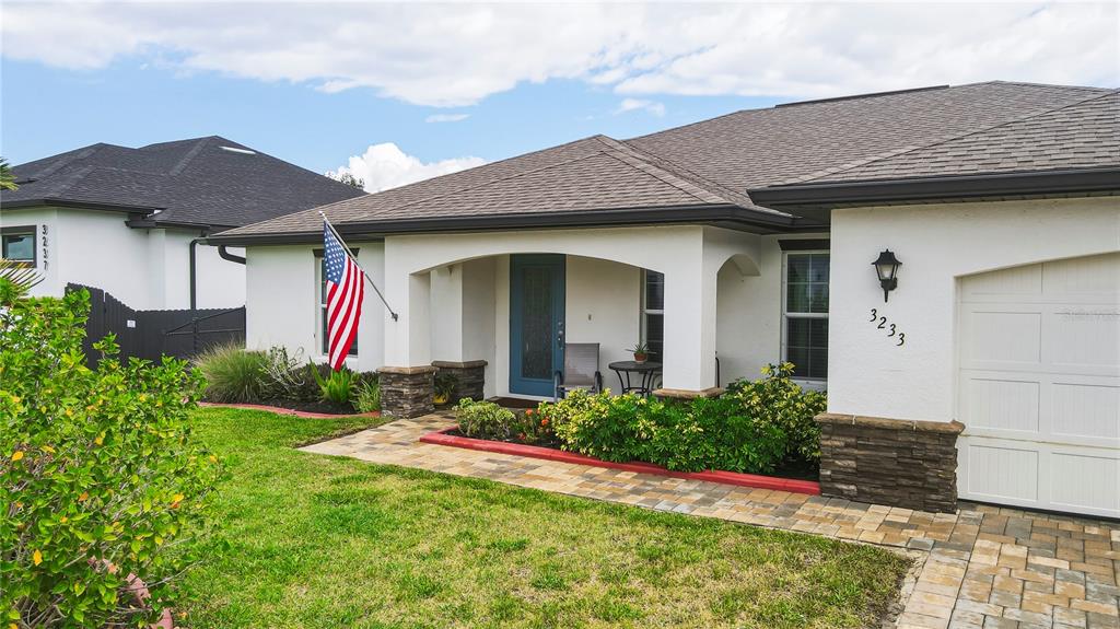 A blue storage shed sits on a paved patio next to a tree and gazebo — 3233 NW 21ST STREET, CAPE CORAL, FL