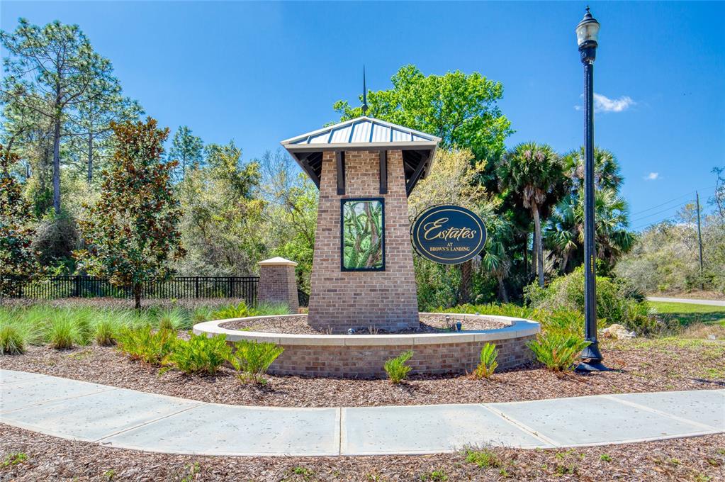 A brick monument sign for Estates at Brown's Landing stands in a landscaped garden area — 1801 ADRIAN CREEK BOULEVARD, PORT ORANGE, FL