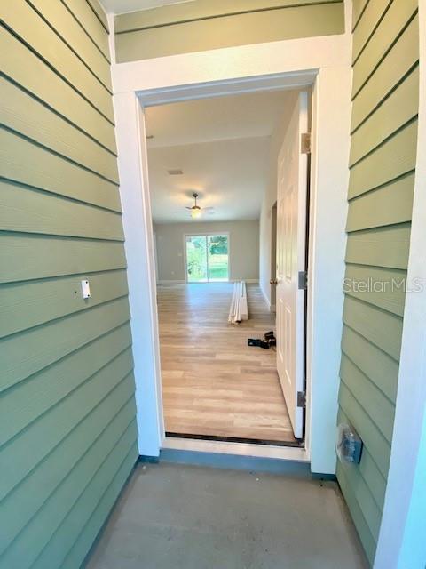A view from a covered porch looking through an open doorway into a bright interior room — 8555 NW 210TH STREET, MICANOPY, FL