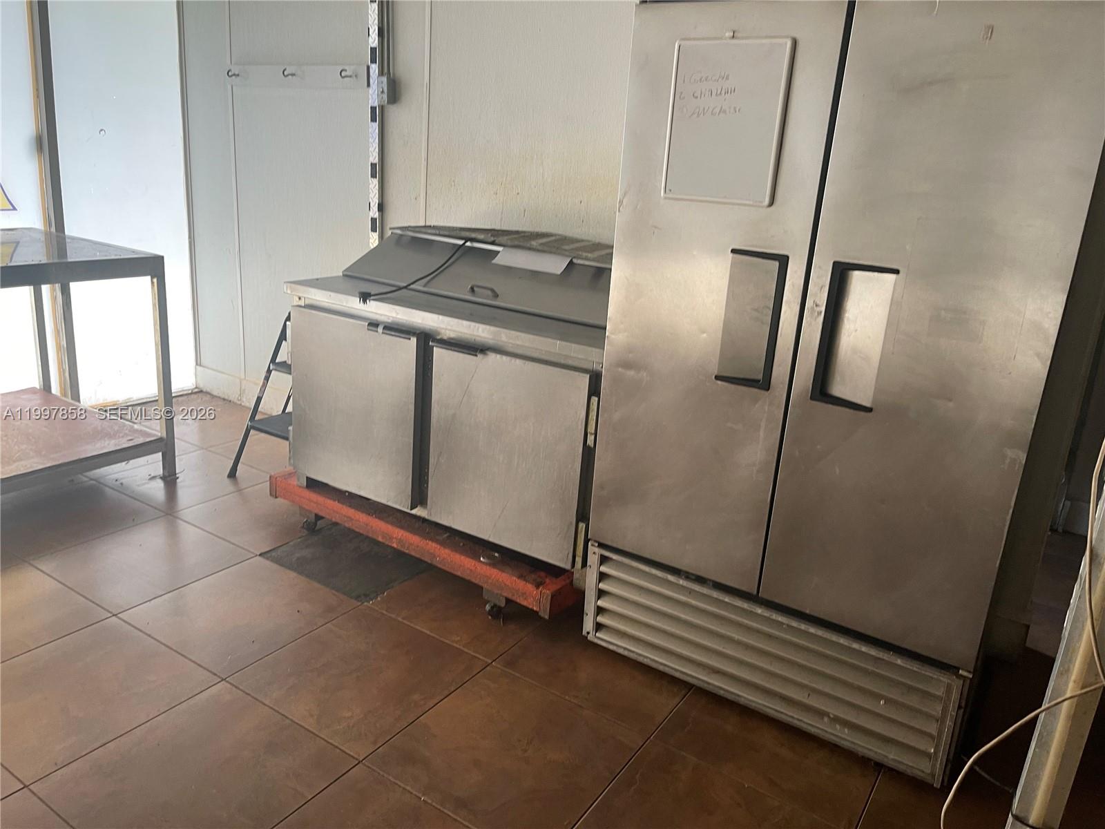 A commercial kitchen features stainless steel refrigeration units on a tiled floor — 1777 SW 3 AV, Miami FL 33129, MIAMI, FL