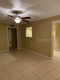 A room with tan walls, a ceiling fan, and light-colored tile flooring — 700 E AIRPORT BOULEVARD UNIT B6, SANFORD, FL