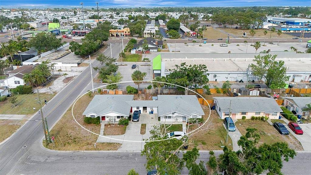 An aerial view shows a single-story duplex with a shared driveway and gray roofs — 6528/ 6530 12TH STREET W, BRADENTON, FL