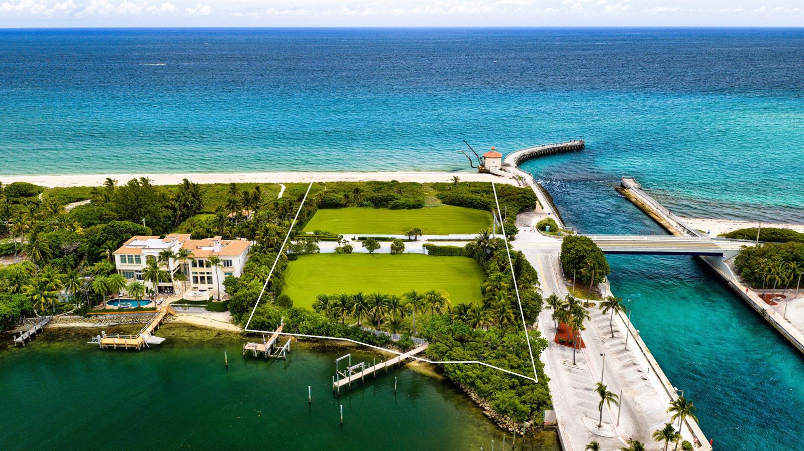 An aerial view shows a large, vacant waterfront lot situated between a mansion and a bridge — 4000 S Ocean Boulevard, Manalapan FL 33462, MANALAPAN, FL
