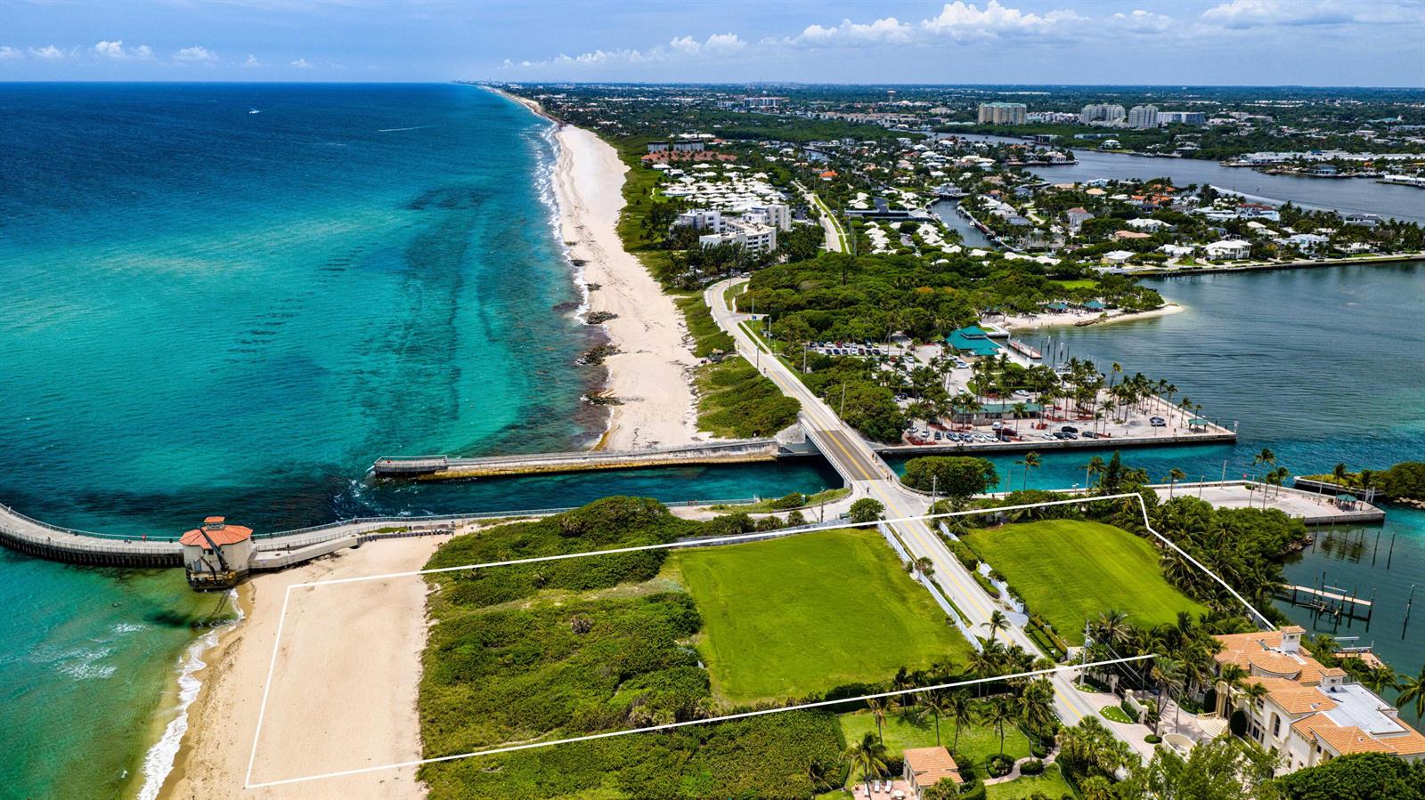 An aerial view shows a coastal property with a large grassy lot near a bridge — 4000 S Ocean Boulevard, Manalapan FL 33462, MANALAPAN, FL