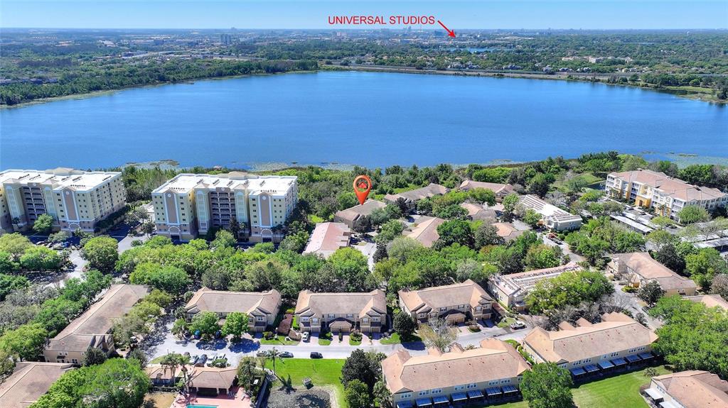 A screened-in porch features a ceiling fan, two chairs, a small table, and backyard views — 6342 DAYSBROOK DRIVE UNIT 103, ORLANDO, FL