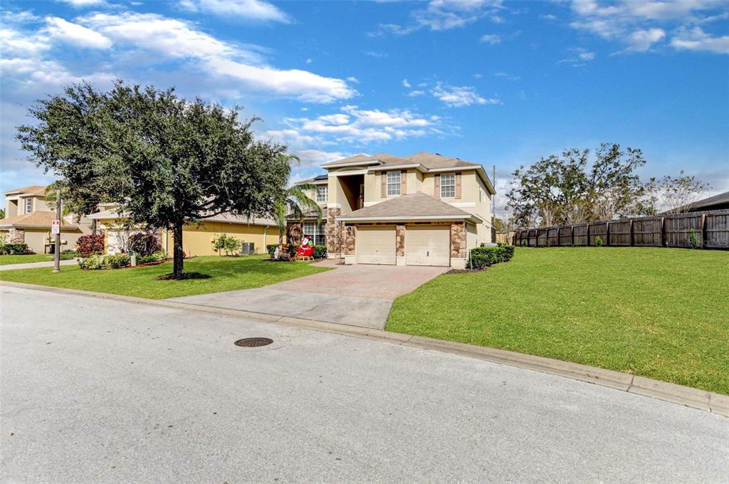 A two-story suburban house with a two-car garage and a large front lawn — 112 CYPRESS POINTE COURT, DAVENPORT, FL