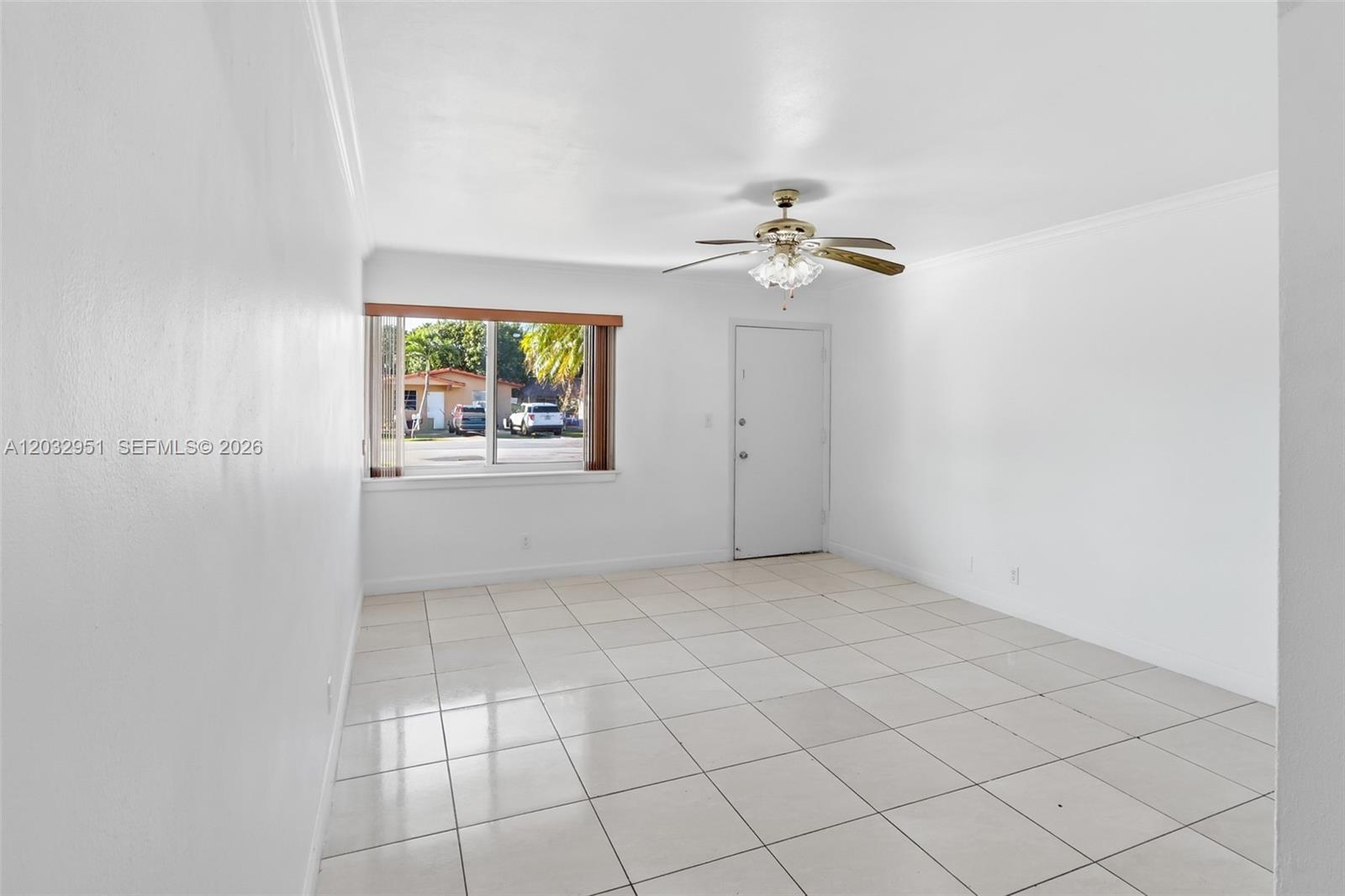 A bright, empty room features white walls, tiled flooring, a ceiling fan, and a window — 11195 SW 1st St # 119, Miami FL 33174, MIAMI, FL