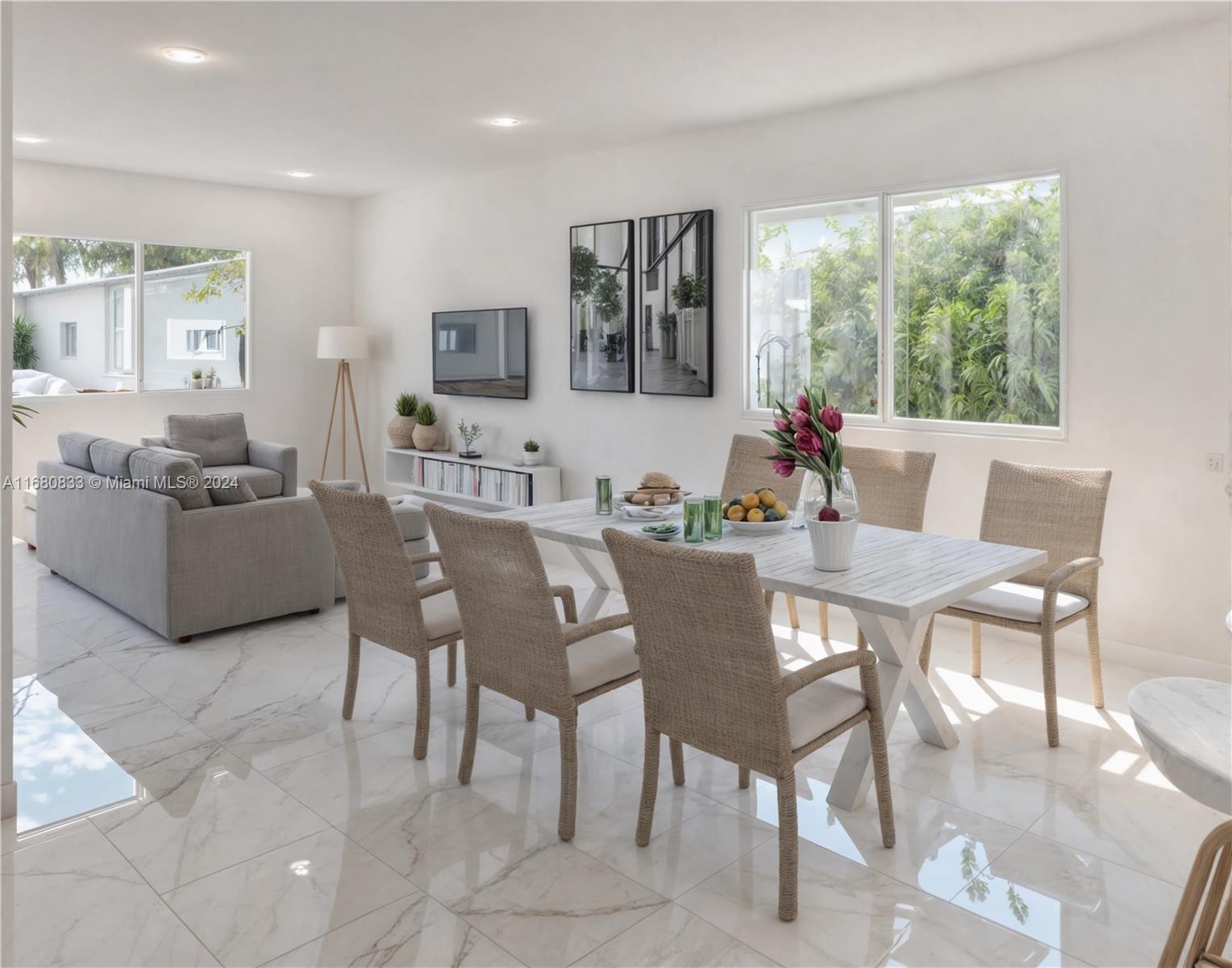 A bright dining and living area features white tile floors, a wooden table, and large windows — 721 NW 5th Ave, Pompano Beach FL 33060, POMPANO BEACH, FL