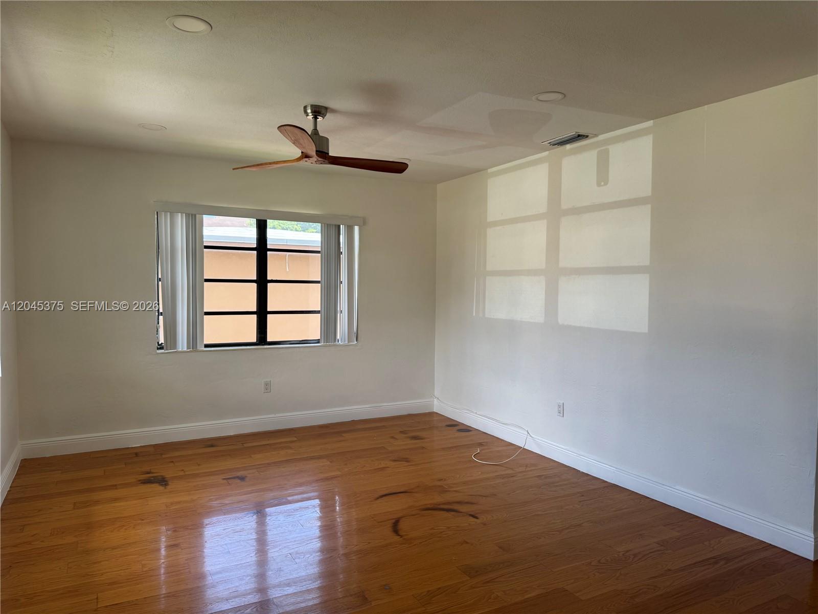 An empty room features hardwood floors, a ceiling fan, and a window with blinds — 3500 SW 87th Pl # 3500, Miami FL 33165, MIAMI, FL