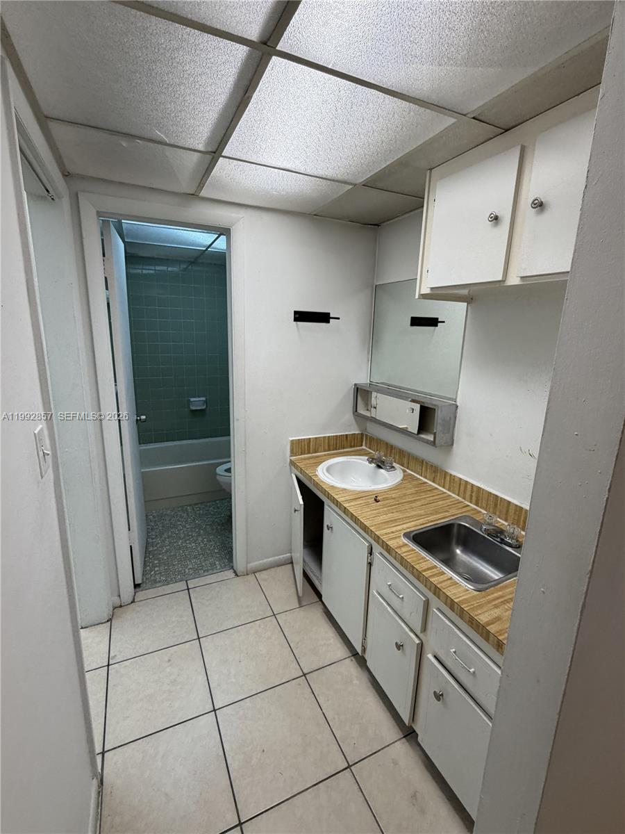 A bathroom features a vanity with a sink, a separate basin, and an adjacent tub area — 7010 NW 186th St # 121A, Hialeah FL 33015, HIALEAH, FL