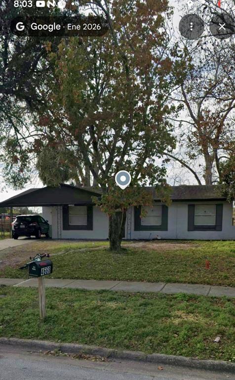 A single-story house with a carport and a large tree in the front yard — 4668 MIRAMAR ROAD, ORLANDO, FL