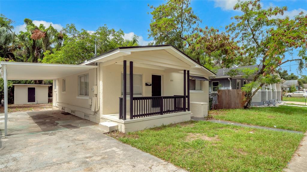 A single-story house with a front porch, a carport, and a detached shed in back — 1213 E 24TH AVENUE, TAMPA, FL