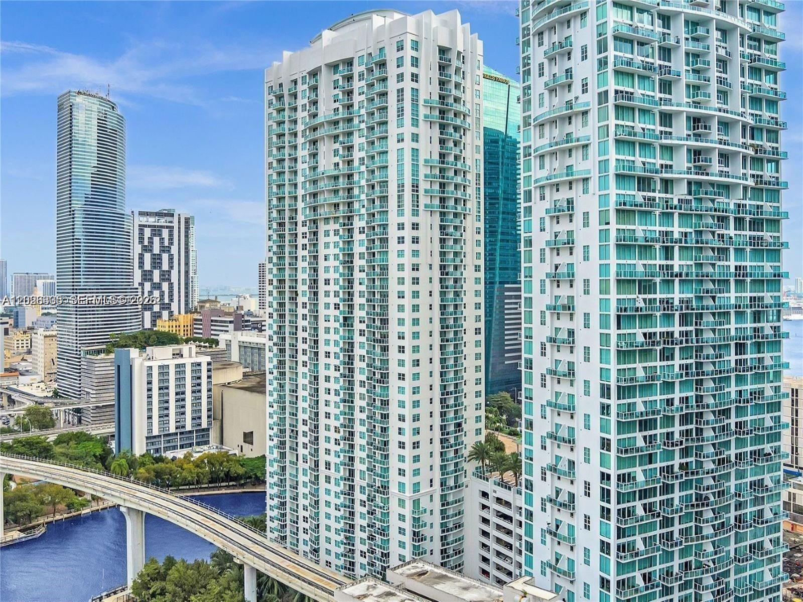 An elevated exterior view of several modern high-rise apartment buildings in a city — 31 SE 5th St # 705, Miami FL 33131, MIAMI, FL