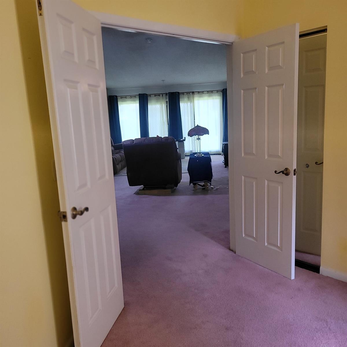 A doorway with open white doors reveals a living room with pink carpeting — 135 Meander Circle, Royal Palm Beach FL 33411, ROYAL PALM BEACH, FL