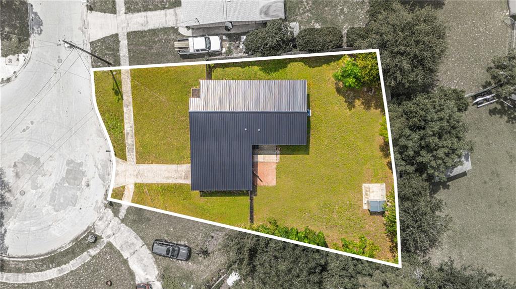 An aerial view shows a house with a dark metal roof on a corner lot — 465 SIGSBEE COURT, ORANGE PARK, FL