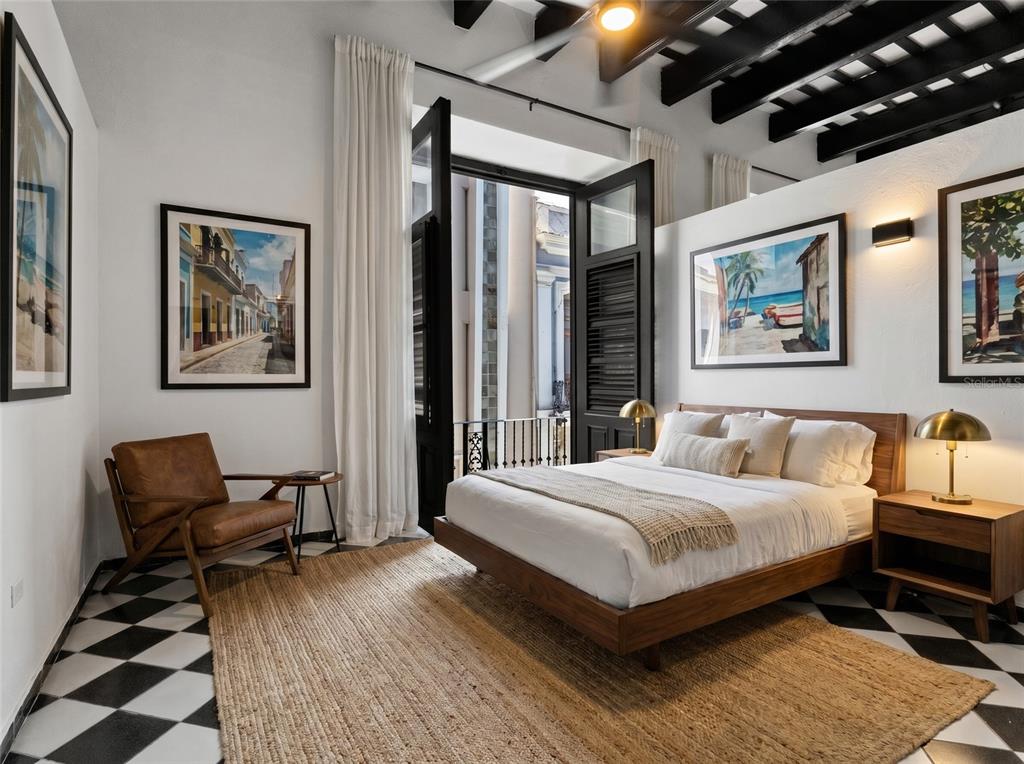 A bedroom features a wooden bed, black and white tiled floors, and a balcony door — 252 CALLE FORTALEZA UNIT 252, SAN JUAN, PR