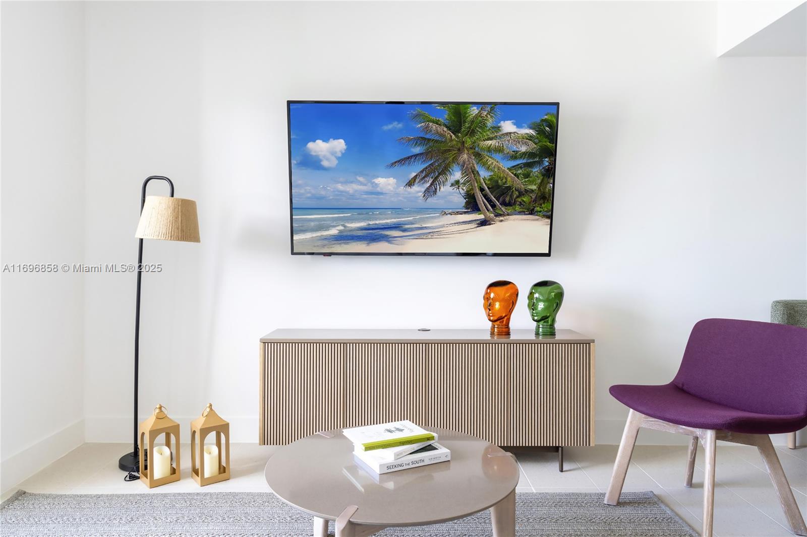 A living room features a wall-mounted television, a slatted media console, and a purple chair — 159 NE 6TH ST # 4513, Miami FL 33132, MIAMI, FL