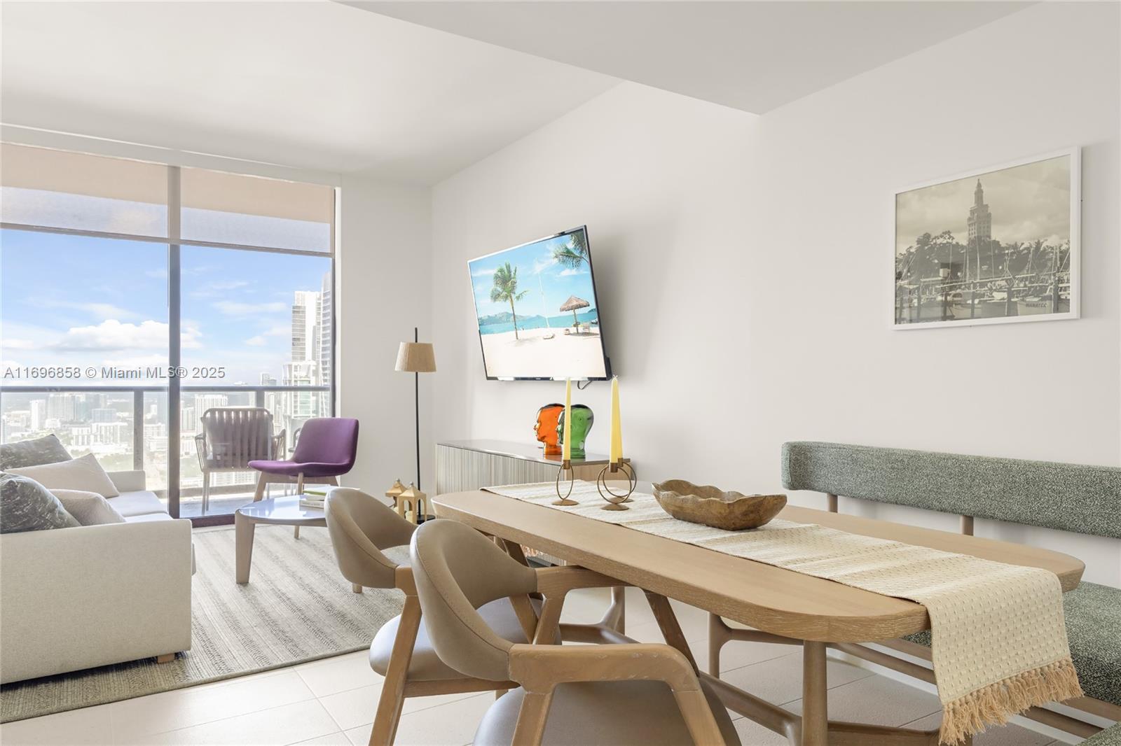 A modern living and dining area features floor-to-ceiling windows with city views — 159 NE 6TH ST # 4513, Miami FL 33132, MIAMI, FL