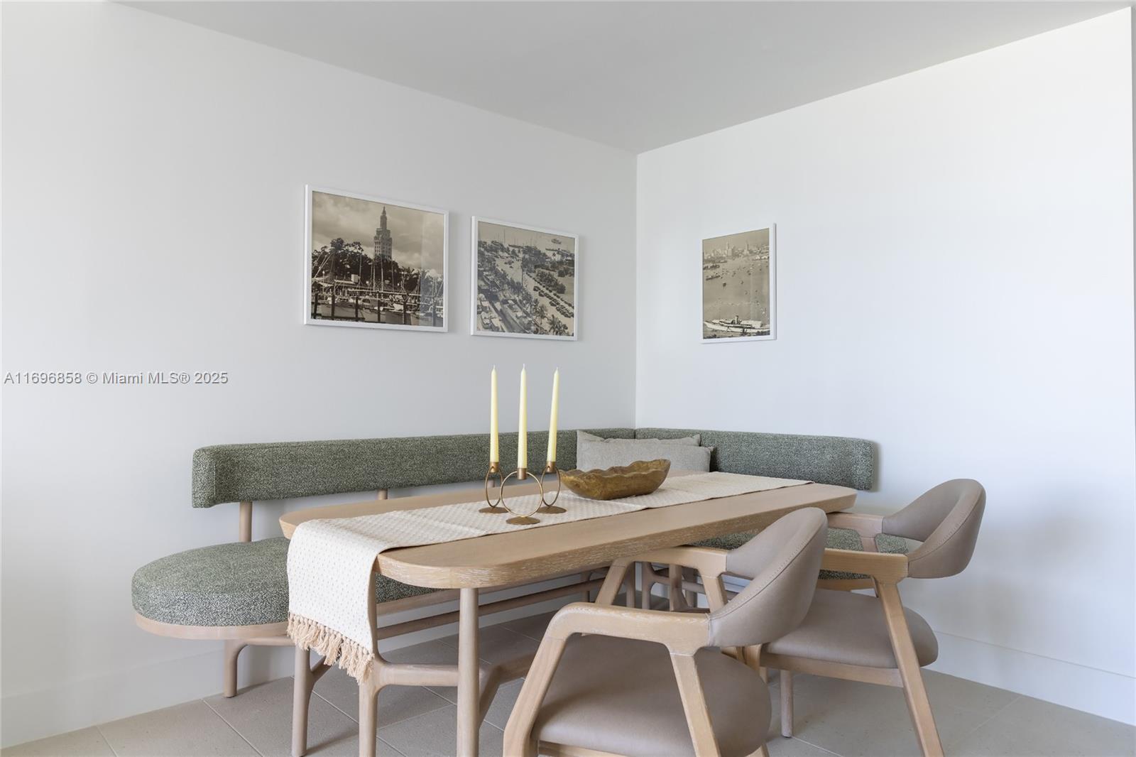 A dining area features a corner banquette, a wooden table, and three framed wall prints — 159 NE 6TH ST # 4513, Miami FL 33132, MIAMI, FL