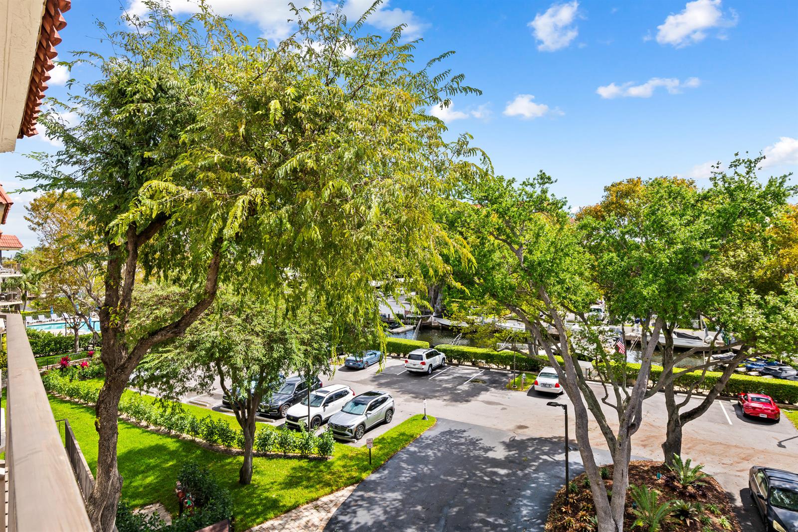 An elevated view of a parking lot surrounded by trees and a canal — 799 Jeffery Street # 4050, Boca Raton FL 33487, BOCA RATON, FL