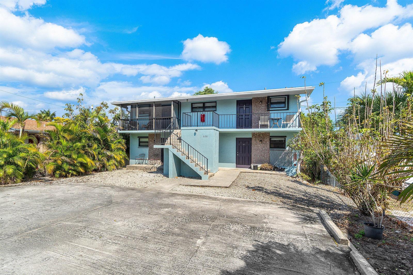 A two-story light blue apartment building with an exterior staircase and a gravel front yard — 626 N Federal Highway Unit 3, FL 33460, FL