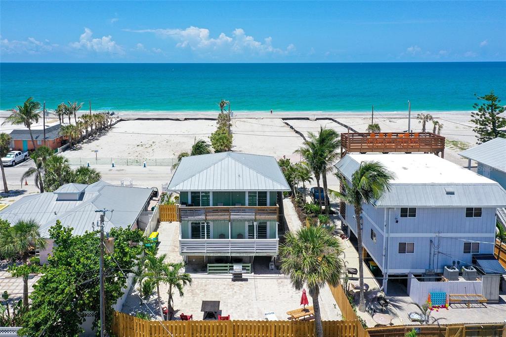 An aerial view of a beach house with a metal roof and a wooden deck — 1103 SHORE VIEW DRIVE, ENGLEWOOD, FL