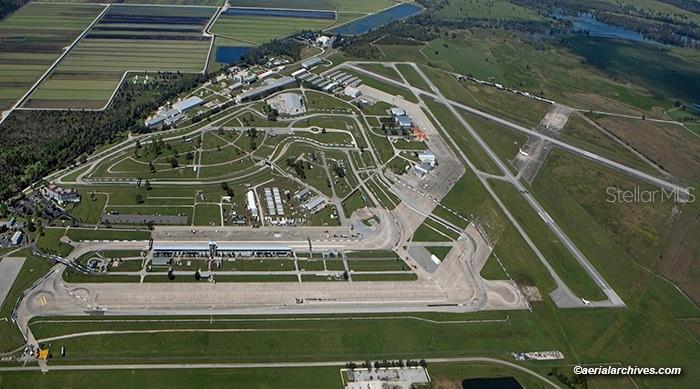 An aerial view shows a racetrack facility adjacent to an airport runway and agricultural fields — 3600 DESOTO CITY ROAD, SEBRING, FL