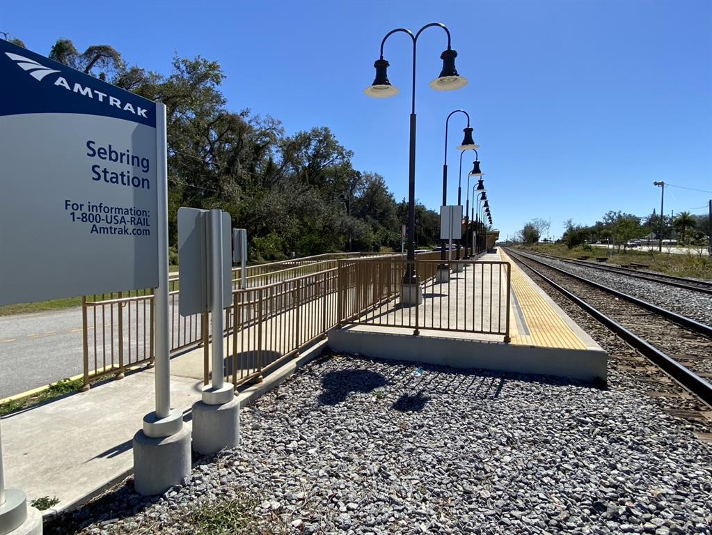 An outdoor view of the Sebring Amtrak train station platform with metal railings and lamps — 3600 DESOTO CITY ROAD, SEBRING, FL