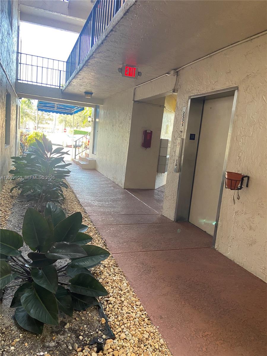 An outdoor walkway leads to an elevator and a set of mailboxes — 7502 NW 30th Pl # 417, Sunrise FL 33313, SUNRISE, FL