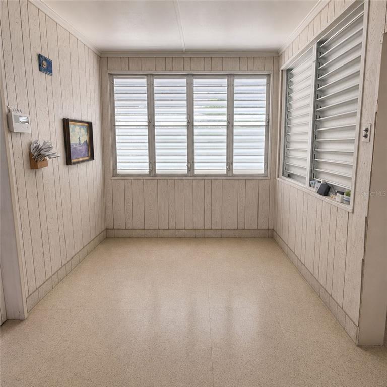 A sunroom with light-colored wood paneling, tile flooring, and multiple louvered windows — PR 523 KM0.3 ROAD, UTUADO, PR