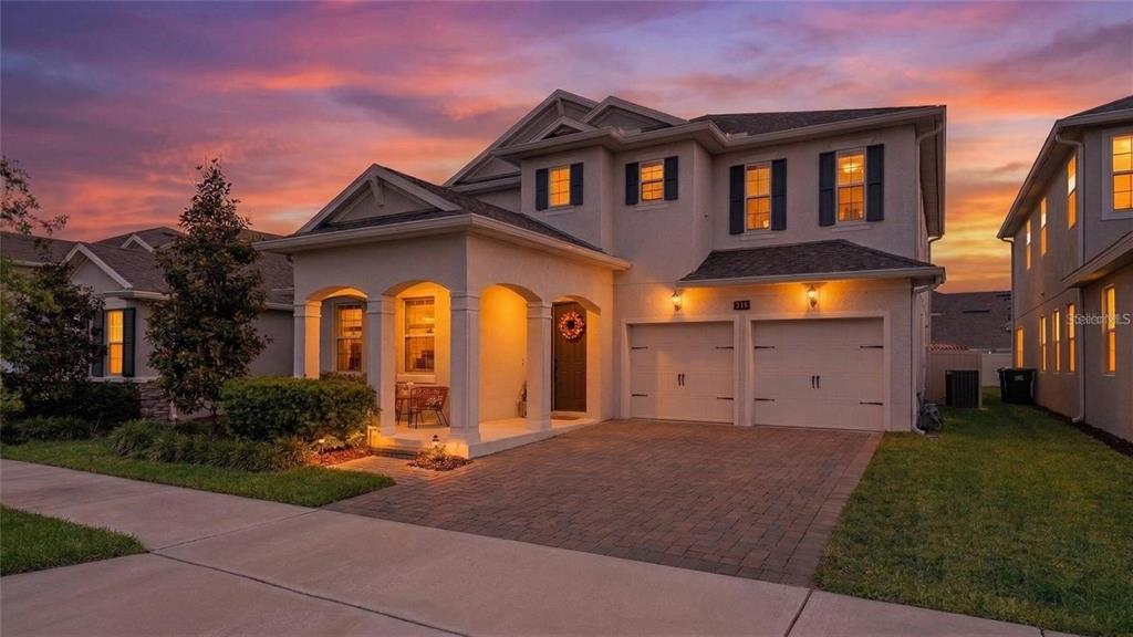 A two-story suburban house with a paved driveway, a covered porch, and a two-car garage — 15239 LAKE LAMONIA ST, WINTER GARDEN, FL