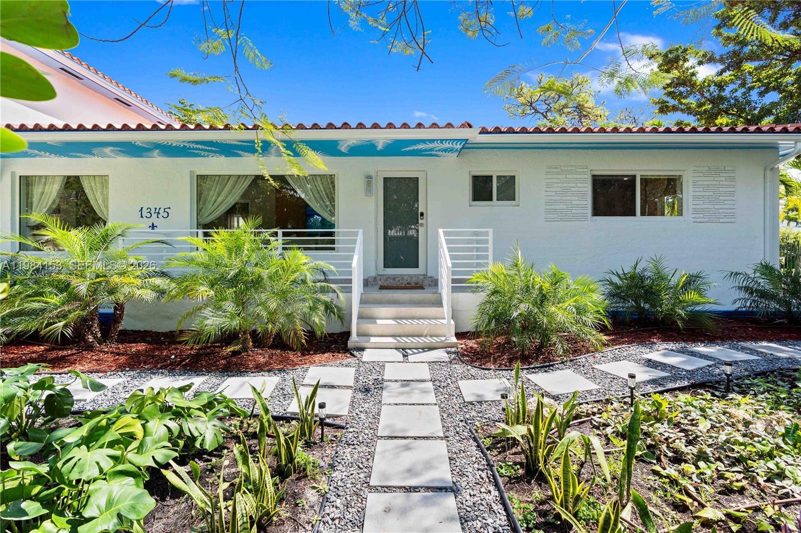 A white single-story house with a tiled roof, palm trees, and a stone walkway — 1345 SW 14th Ave, Miami FL 33145, MIAMI, FL
