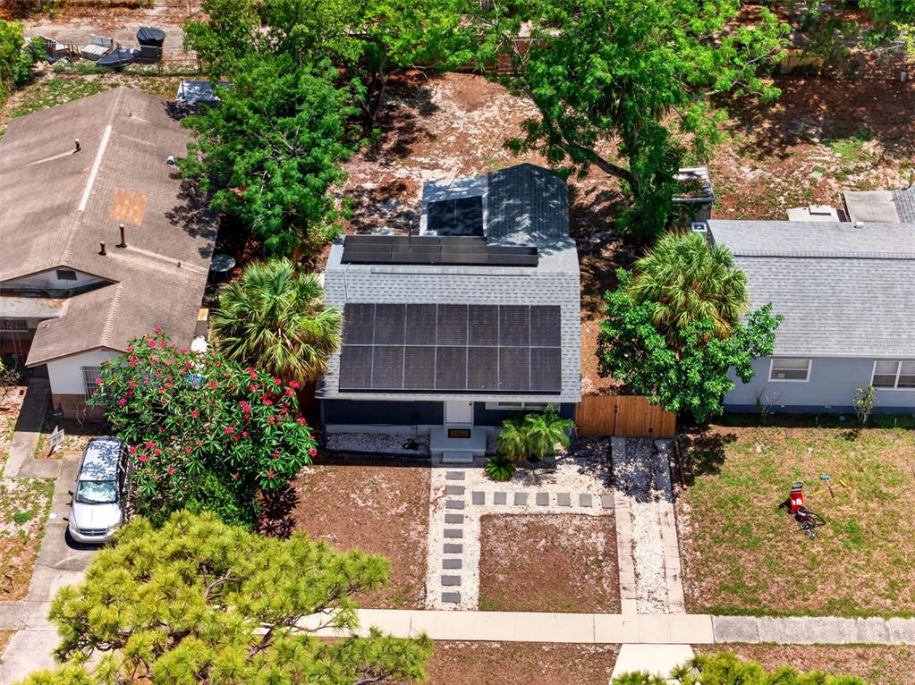 An aerial view of a house with solar panels on the roof and a front yard — 4616 9TH AVENUE S, ST PETERSBURG, FL