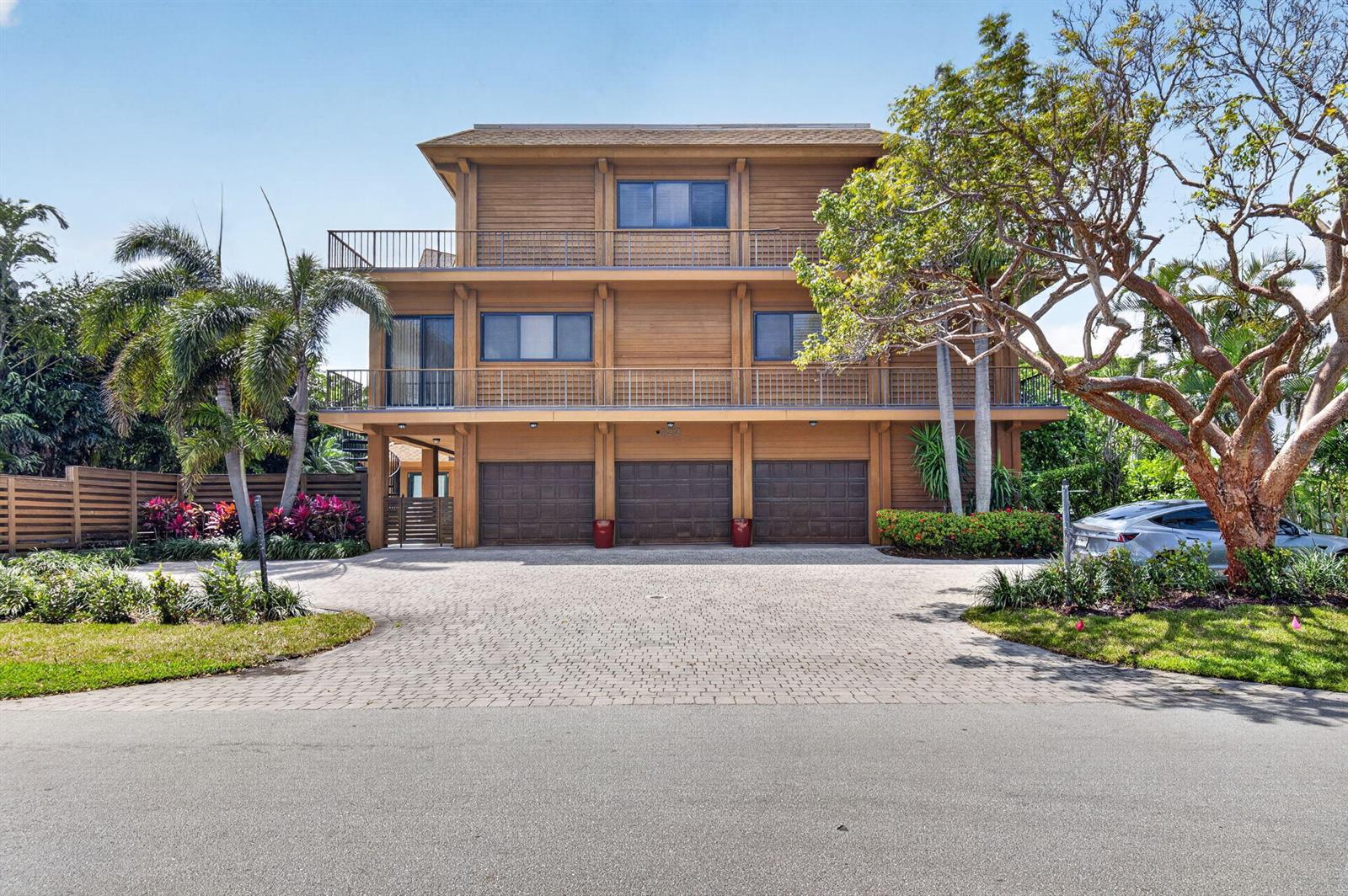 A three-story wooden house with a three-car garage and a paved driveway — 122 Andrews Avenue # B, Delray Beach FL 33483, DELRAY BEACH, FL