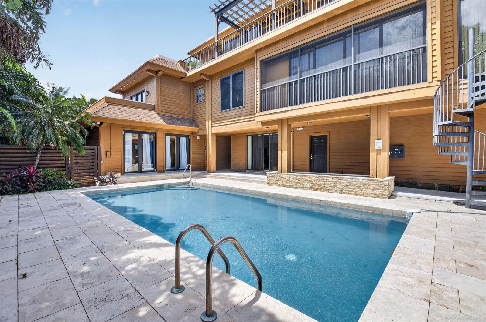 A two-story house with a swimming pool, stone patio, and a metal spiral staircase — 122 Andrews Avenue # B, Delray Beach FL 33483, DELRAY BEACH, FL