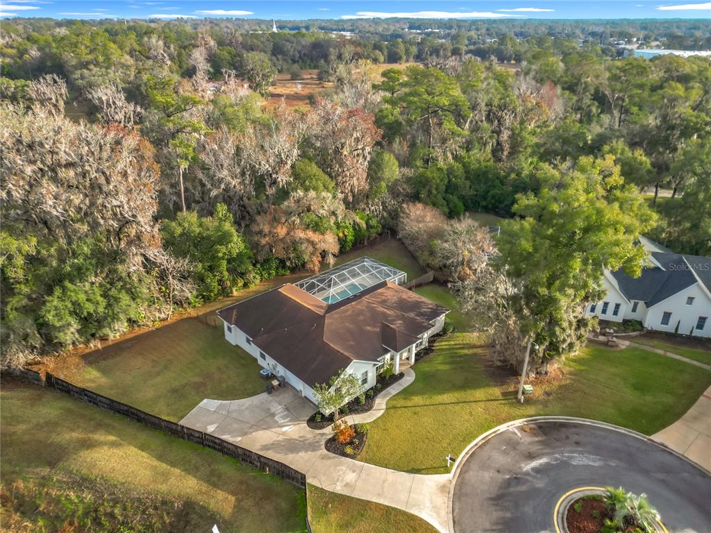 An aerial view shows a single-story house with a screened pool and a circular driveway — 2614 SE 25TH COURT, OCALA, FL