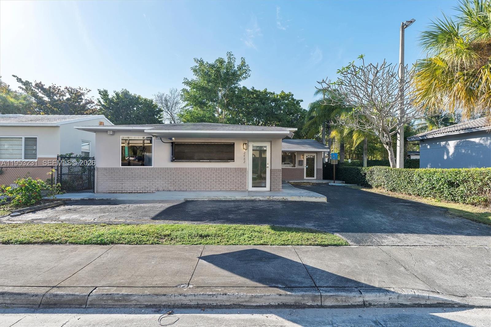 A single-story building with a brick facade, a paved driveway, and a glass front door — 2482 SW Secoffee Ter, Miami FL 33133, MIAMI, FL