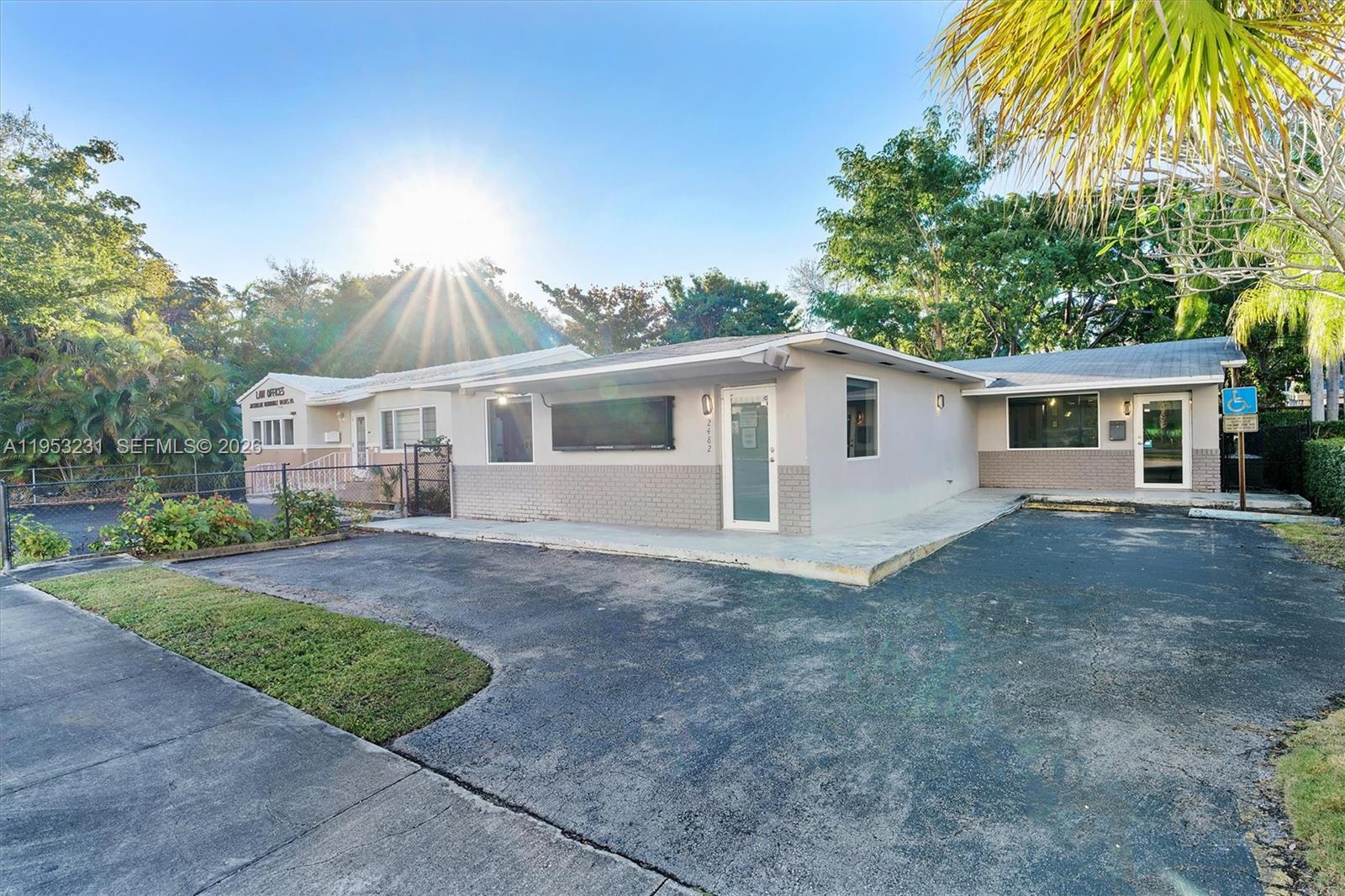 A single-story commercial building with a paved parking lot and a sunlit sky — 2482 SW Secoffee Ter, Miami FL 33133, MIAMI, FL