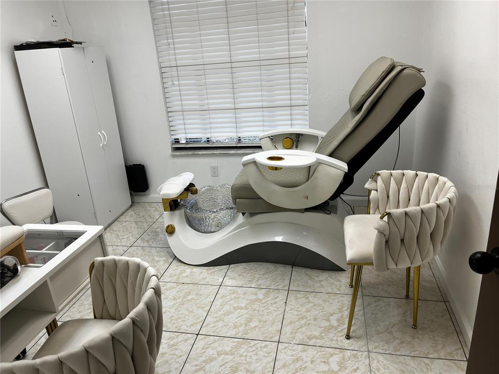 A pedicure chair and two modern chairs are arranged in a small, tiled salon room — 318 N JOHN YOUNG PARKWAY UNIT 103, KISSIMMEE, FL