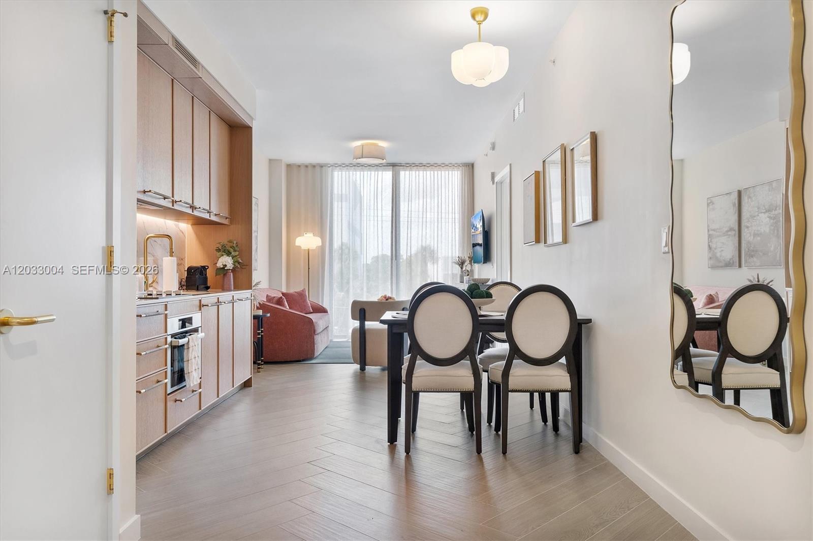 A modern studio apartment features a kitchen, dining area, and living space with wood flooring — 2700 NW 2nd Ave # 230, Miami FL 33127, MIAMI, FL