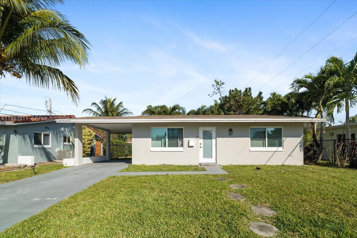 A single-story house with a light gray exterior, a carport, and a front lawn — 5402 NW 25th Ter, Tamarac FL 33309, TAMARAC, FL