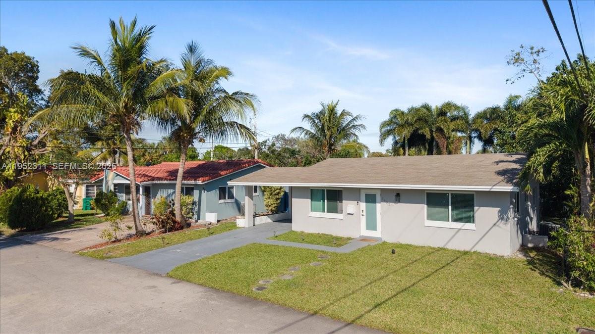 A single-story gray house with a flat roof and a palm-lined front yard — 5402 NW 25th Ter, Tamarac FL 33309, TAMARAC, FL