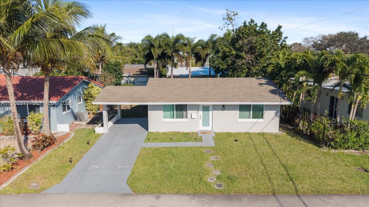 A single-story house with a gray exterior, a carport, and a brown shingled roof — 5402 NW 25th Ter, Tamarac FL 33309, TAMARAC, FL