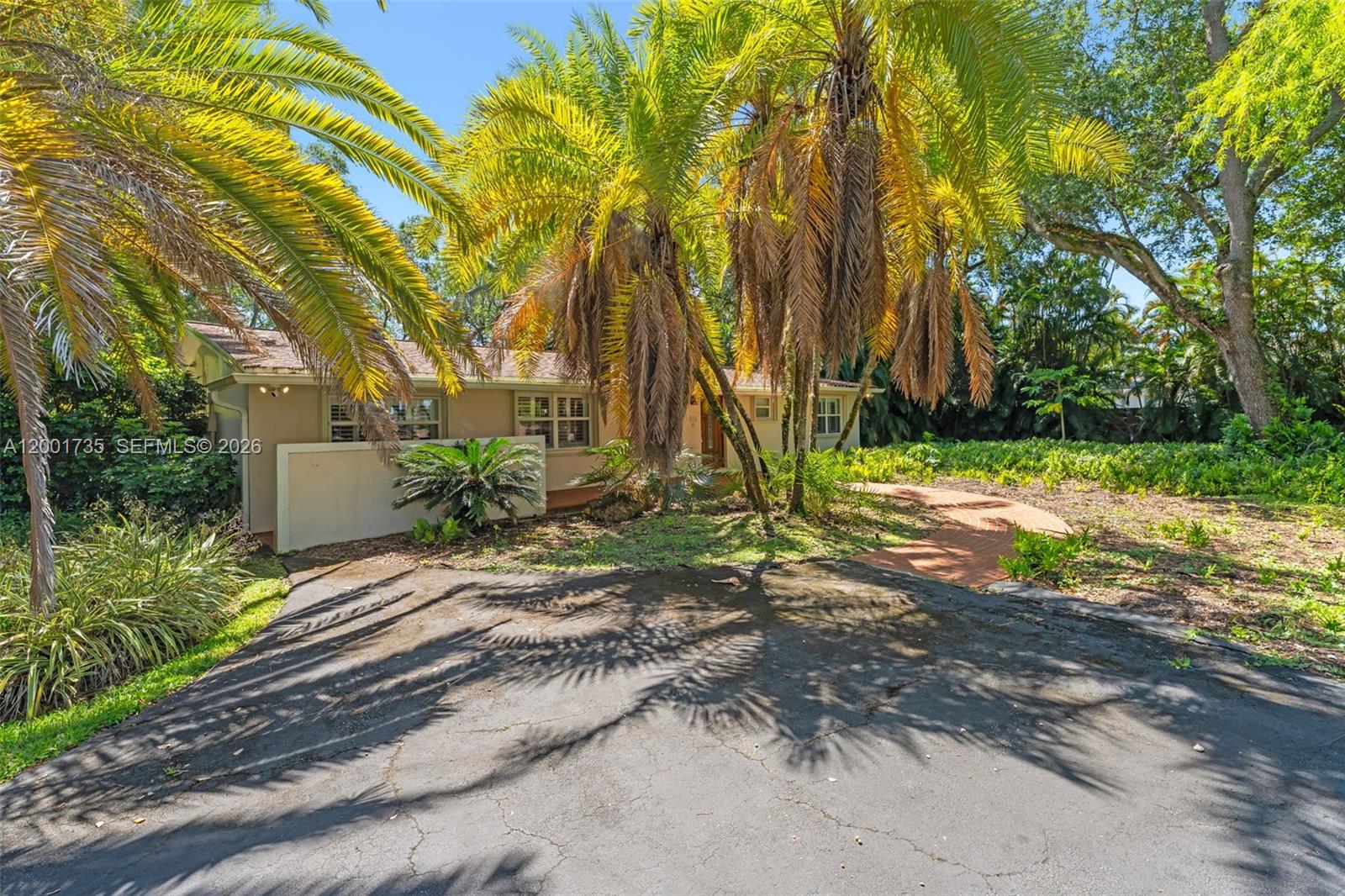 A single-story house with a paved driveway and palm trees in the front yard — 11401 SW 102nd Ave, Miami FL 33176, MIAMI, FL