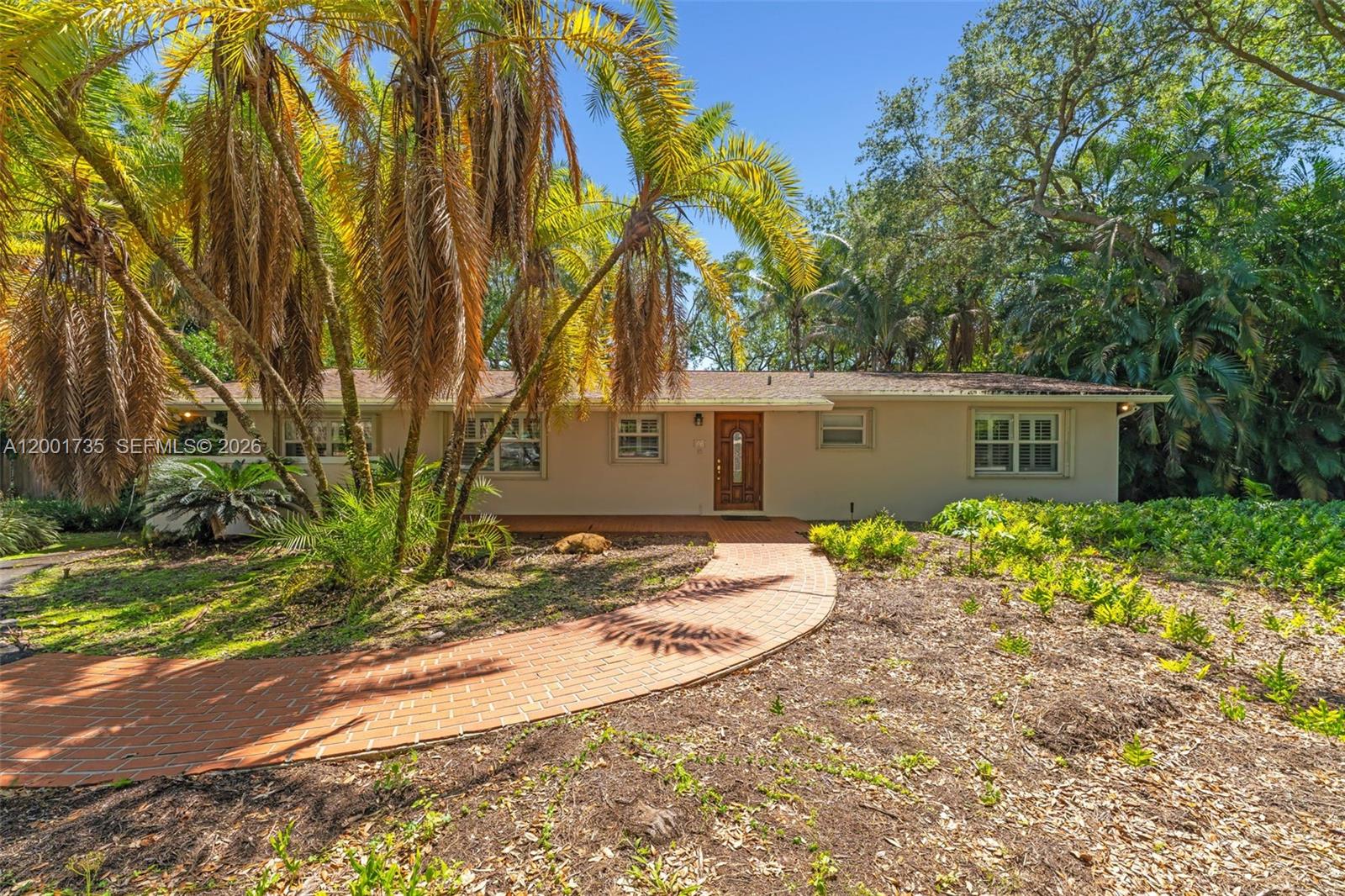 A single-story house with a brick walkway leading to the front door under palm trees — 11401 SW 102nd Ave, Miami FL 33176, MIAMI, FL