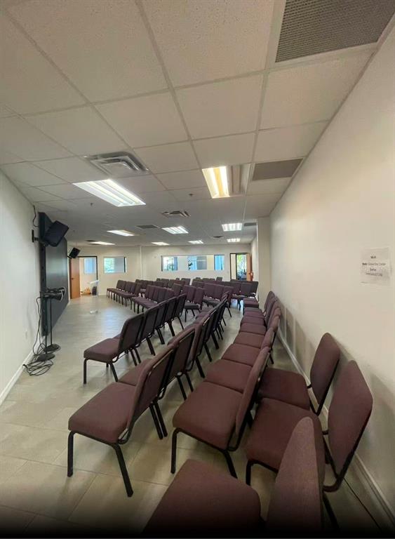A room with rows of purple chairs, tile flooring, and recessed ceiling lights — 7075 KINGSPOINTE PARKWAY UNIT 9, ORLANDO, FL
