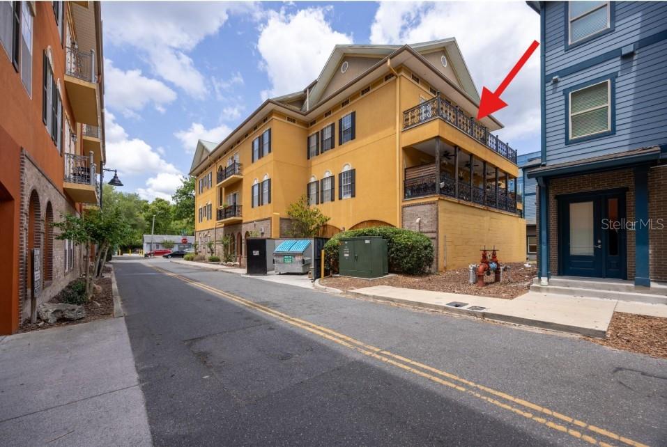 An elevator and a utility room door are set into a yellow stucco wall — 325 NW 14TH STREET UNIT 307, GAINESVILLE, FL